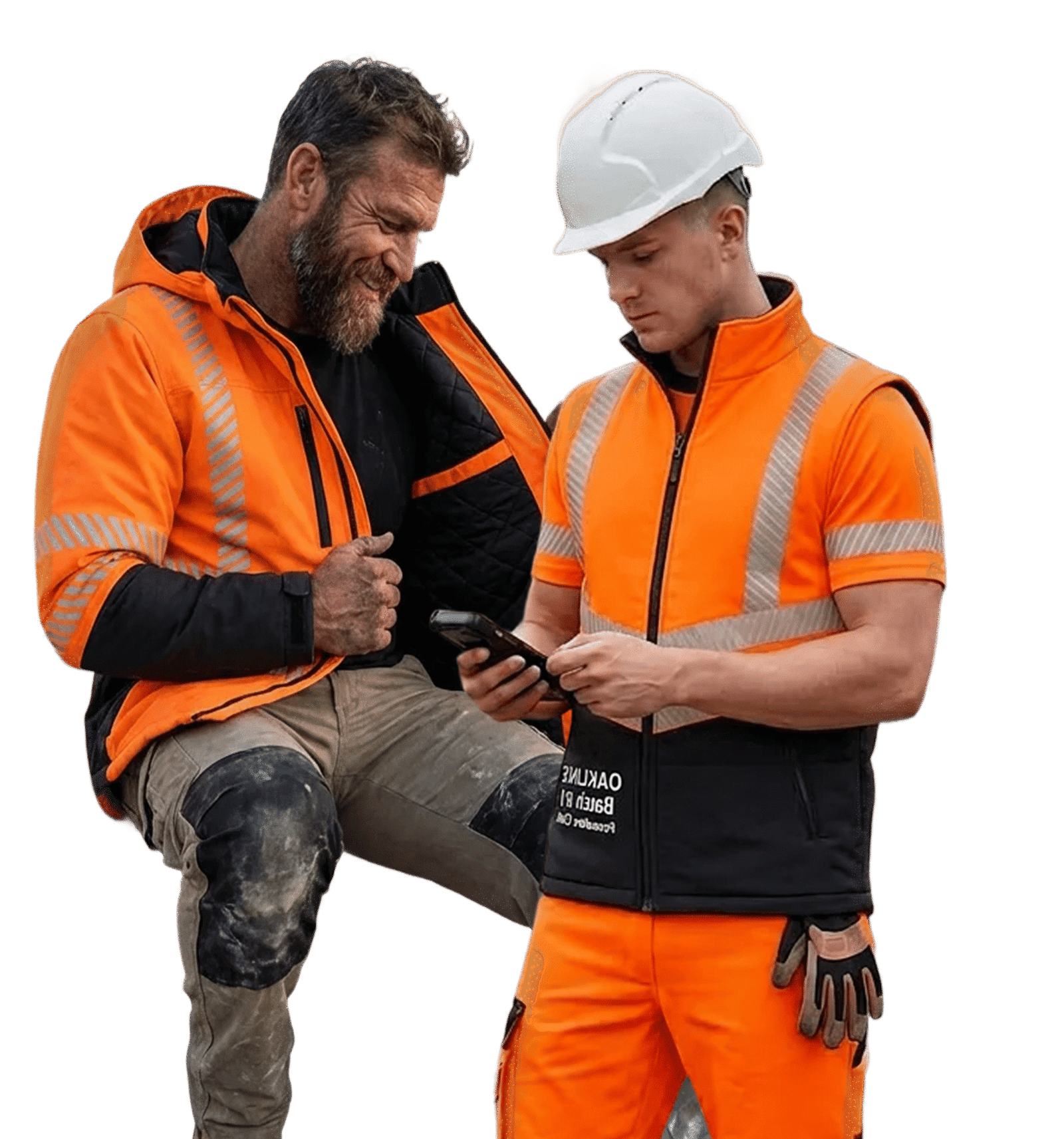 Two construction workers reviewing smartphone on site